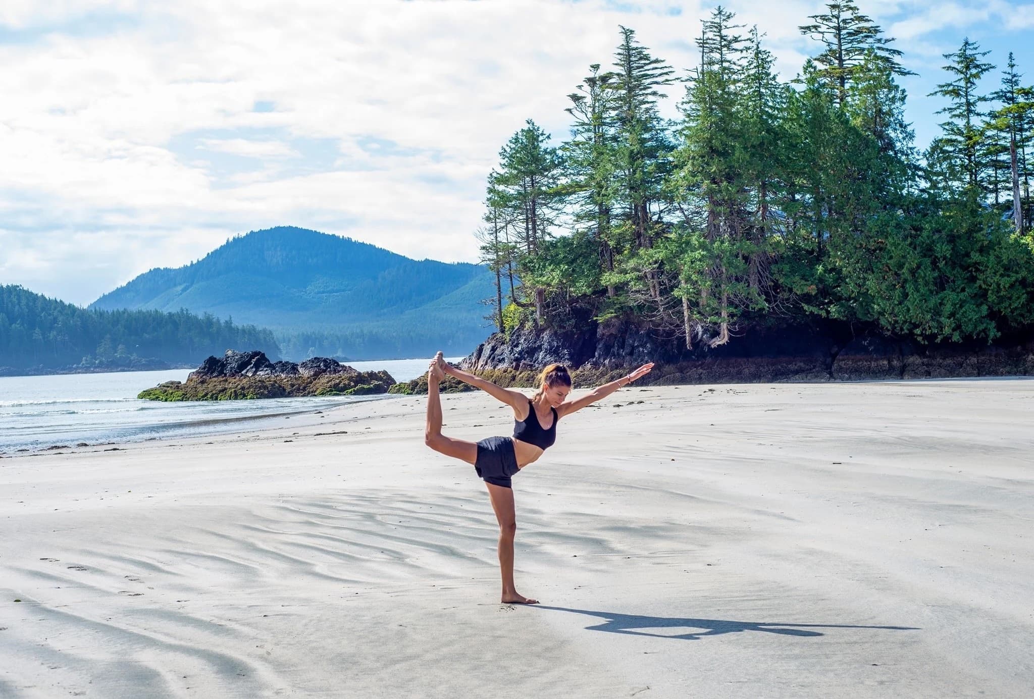 Morgana practicing yoga on the beach
